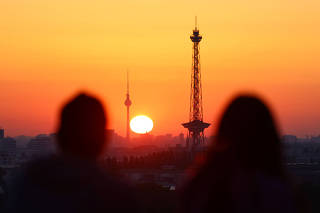 Sun rises behind the skyline of Berlin