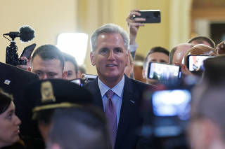U.S. House Speaker Kevin McCarthy walks through crowd of reporters at Capitol in Washington