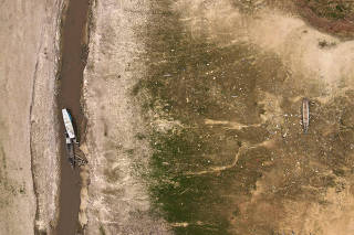 Boats and houseboats are seen stranded in Tefe Lake, which has been affected by the drought, in Tefe, Amazonas state