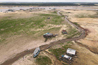 Boats and houseboats are seen stranded in Tefe Lake, which has been affected by the drought, in Tefe, Amazonas state