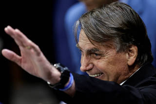 Former Brazilian President Jair Bolsonaro reacts during a session in the Legislative Assembly of Goias to receive the title of citizen of Goias, in Goiania