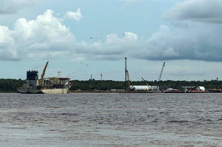A boat to support the oil industry is pictured on the coastline, in Georgetown