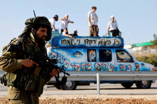 Religious Jewish men play music from a van and dance to encourage Israeli soldiers near Israel's border with Gaza in southern Israel
