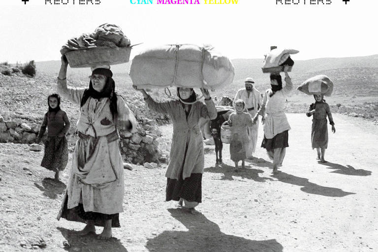 Árabes, carregando seus pertences, fogem de uma vila não identificada na Galileia, no norte do território hoje pertencente a Israel, cerca de cinco meses após a criação do Estado judeu