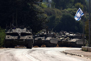 FILE PHOTO: Israeli tanks are seen on a road near Israel's border with Lebanon, in northern Israel
