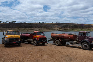 Caminhões-pipa reabastecem em barragem em Betânia do Piau