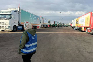 FILE PHOTO: Trucks carrying humanitarian aid from Egyptian NGOs for Palestinians, wait for the reopening of the Rafah crossing at the Egyptian side
