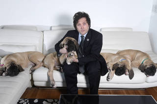 An undated photo provided by Marcelo Dubini/Caras of Javier Milei, a far-right libertarian who might soon be Argentina?s next president, at home with his cloned mastiff puppies in 2018. (Marcelo Dubini/Caras via The New York Times)