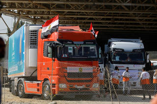 Trucks carrying aid arrive at the Palestinian side of the border with Egypt