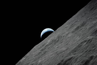 FILE PHOTO: The crescent Earth rises above the lunar horizon in this NASA handout photograph taken from the Apollo 17 spacecraft in lunar orbit