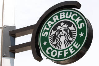 FILE PHOTO: The Starbucks sign is seen outside one of its stores in New York