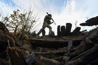 Ukrainian servicemen inspect a former Russian position outside the village of Robotyne in Zaporizhzhia region
