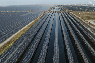 A solar and wind farm in Weifang, China, on Oct. 23, 2023. (Gilles Sabrié/The New York Times)
