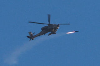 An Apache helicopter fires a missile as seen from Sderot