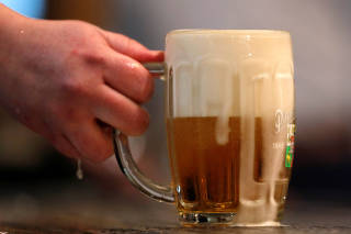 A bartender pours a glass of beer in Prague