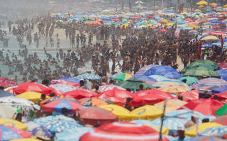 People gather on the Ipanema beach in Rio de Janeiro