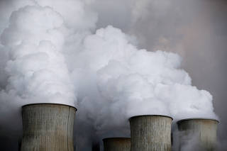 FILE PHOTO: FILE PHOTO: Steam rises from the cooling towers of the coal power plant of RWE in Niederaussem