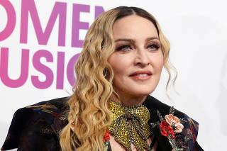 Madonna poses on the red carpet a the Billboard Magazine's 11th annual Women in Music luncheon in New York