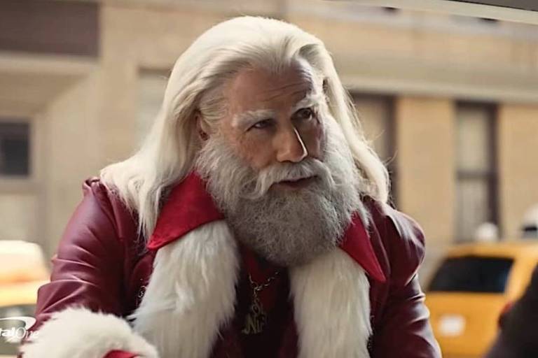Em foto colorida, homem aparece vestido de Papai Noel em um comercial de TV