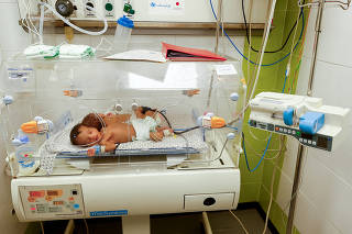 FILE PHOTO: Premature baby evacuated from Al Shifa Hospital lies in an incubator in Rafah