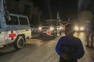Vehicles with the International Committee of the Red Cross believed to be carrying hostages released by Hamas head through the border crossing with Egypt in Rafah, in the southern Gaza Strip, Nov. 24, 2023. (Samar Abu Elouf/The New York Times)