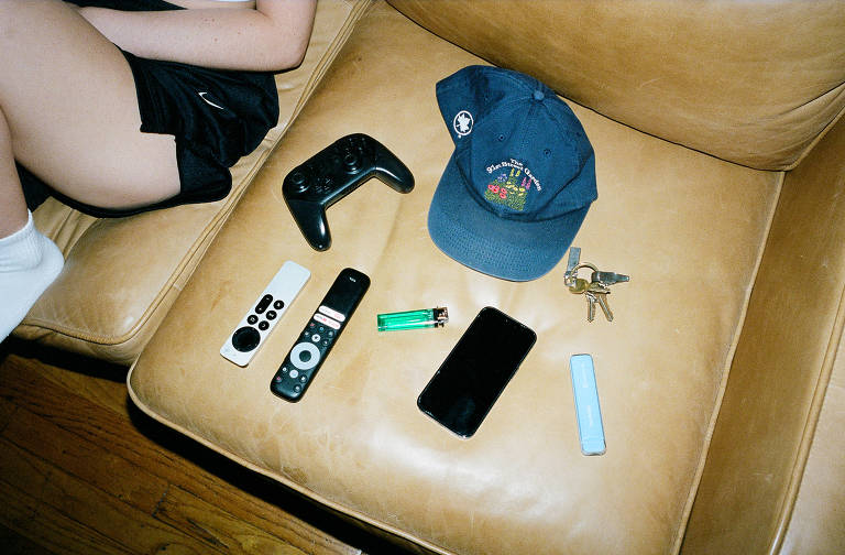 Vape com outros itens em um sofá em Nova York; para alguns jovens usuários que têm lutado para parar de fumar, os vapes são um fato praticamente inevitável da vida: os dispositivos estão sempre à mão e sempre há uma nova cor ou sabor para experimentar