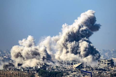 This picture taken from southern Israel near the border with the Gaza Strip shows smoke rising from buildings after being hit by Israeli strikes, as battles resume between Israel and Hamas militants, on December 1, 2023. A temporary truce between Israel and Hamas expired on December 1, with the Israeli army saying combat operations had resumed, accusing Hamas of violating the operational pause. (Photo by John MACDOUGALL / AFP)