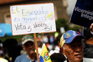 FILE PHOTO: People march in support of a referendum over disputed territory, in Caracas