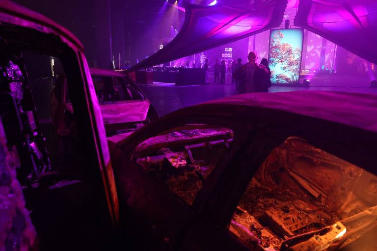 Carros destruídos de frequentadores de rave no deserto de Negev invadida pelo Hamas são exibidos na mostra '06:29', em Tel Aviv