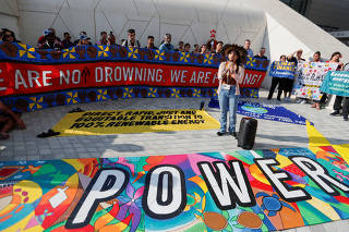 Walelasoetxeige Paiter Bandeira Surui, addresses Climate activists from the Pacific at a protest during the United Nations Climate Change Conference in Dubai