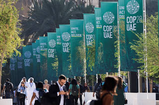 Delegates walk at the United Nations Climate Change Conference COP28 in Dubai