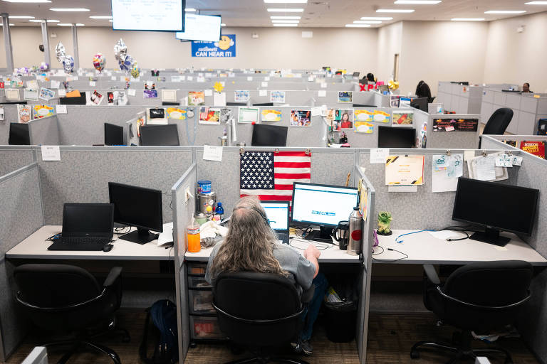  An office worker in Montgomery, Ala., on April 16, 2020. Modular office furniture, which became cubes that tightly packed people together, was introduced in the years after World War II.  (Bob Miller/The New York Times)