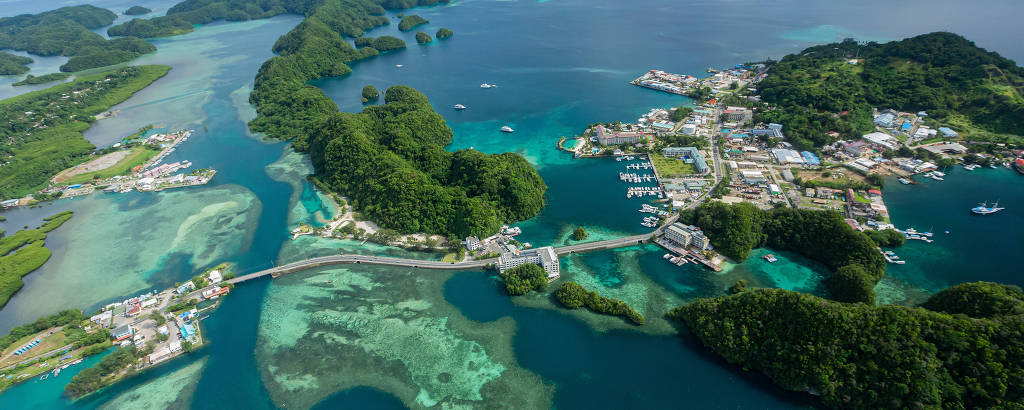 Vista aérea do arquipélago com água azul e cristalina e pequenas porções de terra com marinas