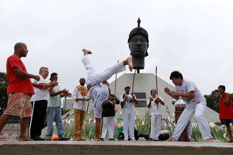 Grupo de capoeira joga em frente a estátua de Zumbi dos Palmares no Rio de Janeiro