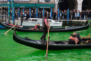 Waters of Grand Canal turned green after a protest by 'Extinction Rebellion' climate activists in Venice
