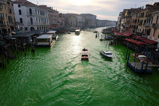 Waters of Grand Canal turned green after a protest by 'Extinction Rebellion' climate activists in Venice