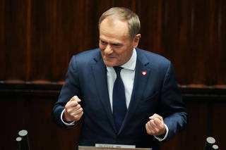 Leader of the Civic Coalition (KO) Donald Tusk reacts after the Parliament voted in favor of him becoming the Prime Minister, in Parliament, in Warsaw