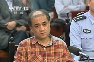 Uighur academic Ilham Tohti sits during his trial on separatism charges in Urumqi, Xinjiang region