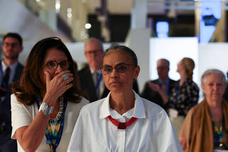 Brazil's Environment and Climate Change Minister Marina Silva walks with delgates during the final stages of the United Nations Climate Change Conference COP28, in Dubai