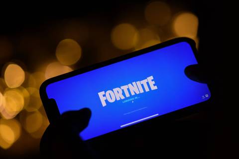 (FILES) This illustration picture shows a person logging into Epic Games' Fortnite on their smartphone in Los Angeles on August 14, 2020. Epic Games, the maker of Fortnite, won a major US court battle against Google on December 11, when a jury decided that the search engine giant wields illegal monopoly power through its Android app store.
Epic sued Google and Apple in 2020, accusing the tech titans of abusing control of their respective shops selling apps and other digital content for mobile devices powered by iOS or Android software. (Photo by Chris DELMAS / AFP)