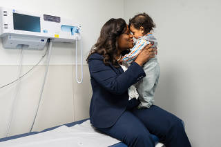 New York state Assemblywoman Rodneyse Bichotte Hermelyn, who pushed for the law that now requires hospitals to care for women in preterm labor, with her son, Daniel, at a health center in New York, June 2, 2023. (James Estrin/The New York Times)