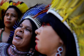 Brazil's Minister of Indigenous Peoples Sonia Guajajara speaks next to Indigenous Congresswoman Celia Xakriaba, during a protest outside the National Congress, in Brasilia