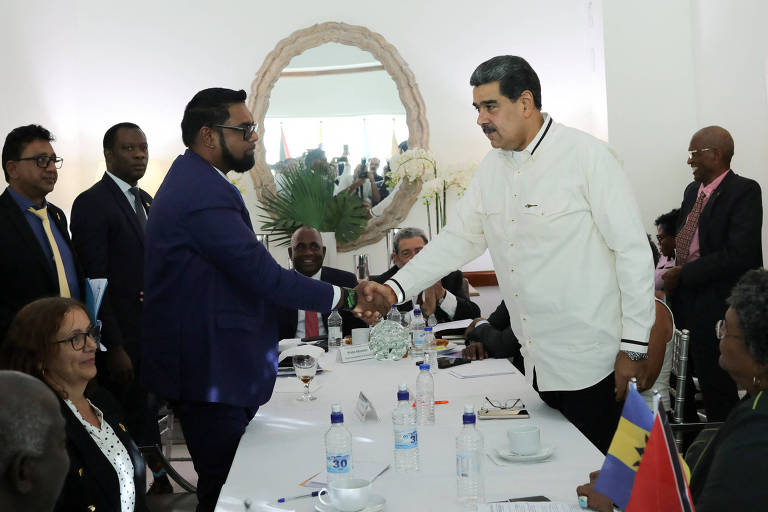 O ditador venezuelano Nicolás Maduro, e o presidente guianense, Irfaan Ali, cumprimentam-se em reunião para amenizar tensões sobre disputa de Essequibo, em Kingston, São Vicente e Granadinas