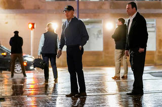 U.S. President Biden reacts to a vehicle crashing into a Secret Service SUV that was blocking the street, in Wilmington