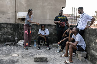 Mariam Dosso, a rapper who goes by the stage name Marla, left, practices her act, combining French words with Ivorian slang, as other rappers listen on a rooftop in Abidjan, Ivory Coast, Feb. 11, 2023. (Arlette Bashizi/The New York Times)