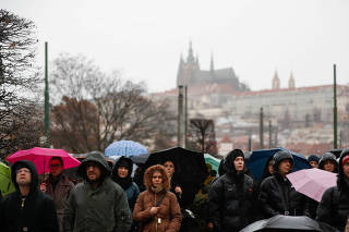 People observe a minute of silence in memory of the victims of the Charles University shooting, in Prague