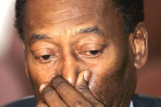 Brazilian soccer legend Pele reacts during news conference in Sao Paulo
