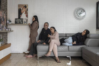 Gal Abdush?s parents, center, and her sisters at their home in Kiryat Ekron, a small town in central Israel, Dec. 7, 2023. (Avishag Shaar-Yashuv/The New York Times)