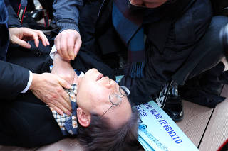 South Korea's opposition party leader Lee Jae-myung falls after being attacked by an unidentified man during his visit to Busan