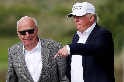FILE PHOTO: Republican presidential candidate Donald Trump (R) speaks to media mogul Rupert Murdoch as they walk out of Trump International Golf Links in Aberdeen, Scotland, June 25, 2016.  REUTERS/Carlo Allegri/File Photo ORG XMIT: FW1
